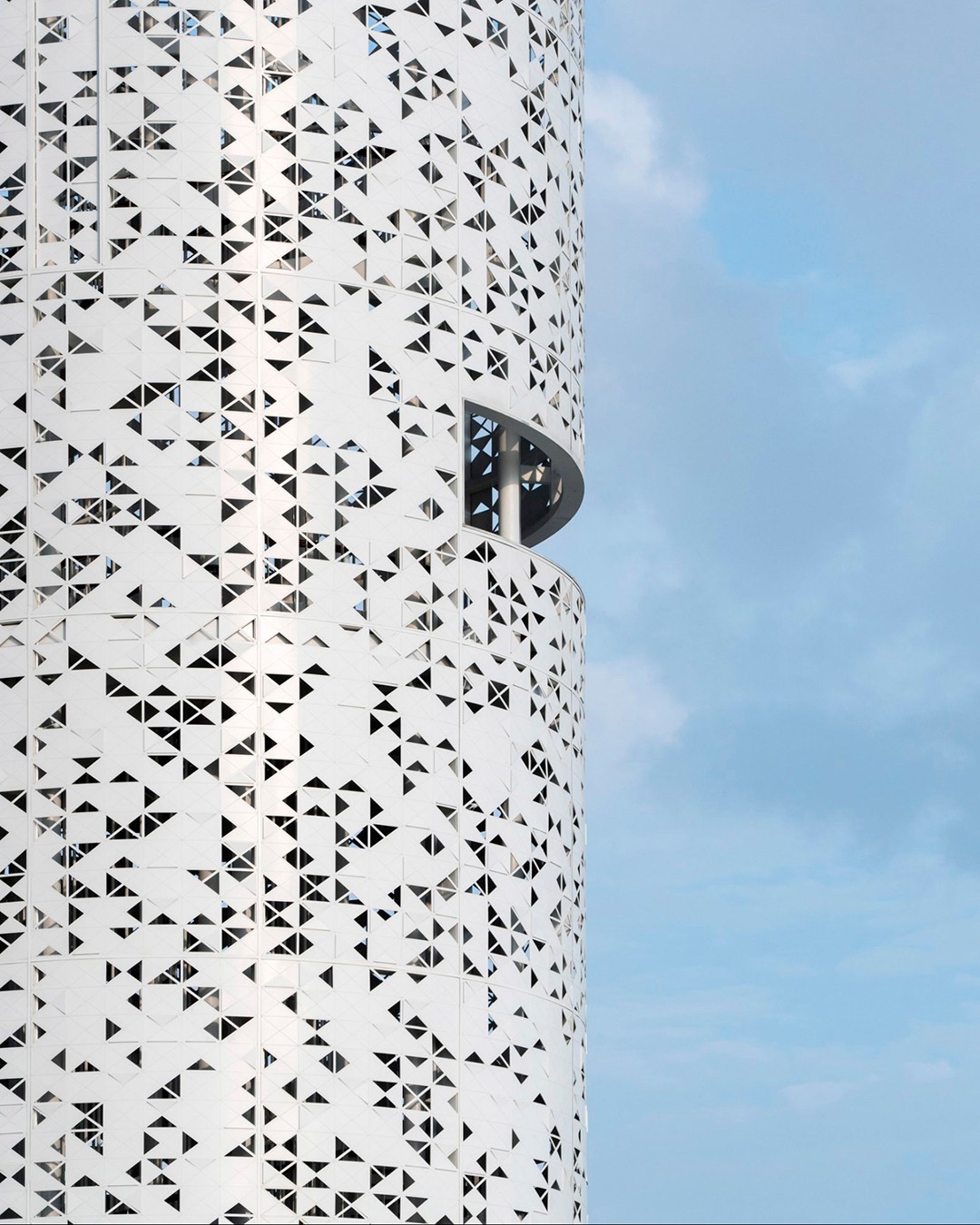Poised observation 💡
The Lunar Tower is a 33.5‑metre observation structure located within the Dongzhai Harbour Mangrove Natural Reserve on Hainan Island near Haikou. Its slender cylindrical form rises subtly from the wetland landscape and is clad in low‑reflective, perforated aluminium panels inspired by surrounding mangrove foliage, balancing durability with minimal visual impact. Three elevated platforms, accessed via a central spiral stair, offer layered views of the forest, waterways, and distant sea.
The tower functions as a panoramic lookout, a platform for environmental monitoring, and a landmark integrated with its natural surroundings. Lighting and material choices are carefully considered to protect wildlife while framing the environment and sky, demonstrating how contemporary architecture can harmonise human experience with sensitive ecosystems.
#Architecture #ObservationTower #SustainableDesign #MangroveConservation